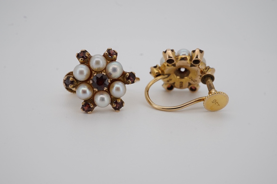 A pair of 9ct, cultured pearl and garnet set flower head ear clips, diameter 14mm, gross weight 4 grams. Condition - fair to good